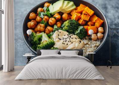 Vegan Buddha Bowl. A hearty bowl with a base of brown rice or quinoa, topped with roasted sweet potatoes, chickpeas, steamed broccoli, avocado, and a drizzle of tahini sauce Wall mural