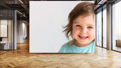 Beautiful happy toddler child girl smiling, portrait neutral background, space for text Wall mural