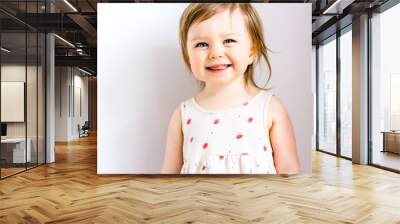 Happy smiling funny toddler child girl on white background Wall mural