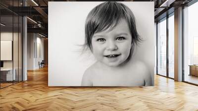 Little girl smiling isolated, black and white Wall mural