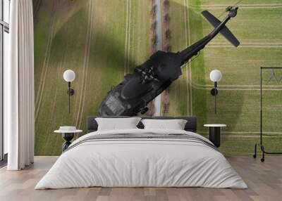 
Black Hawk military Helicopter in flight - aerial view close up Wall mural