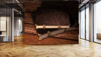 two old leather books with metal claps on wooden table  Wall mural