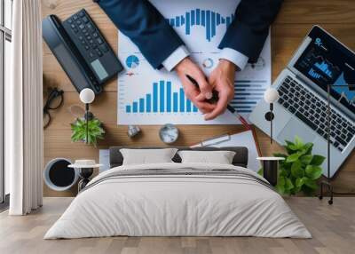 Business professional analyzing financial charts on desk. Office workspace and financial analysis concept Wall mural