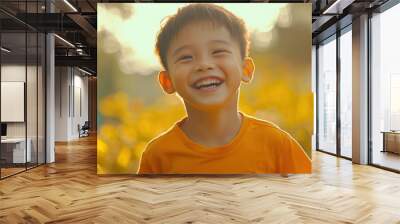 Young boy smiling in sunlit park. Warm golden hour portrait. Childhood and joy concept for family Wall mural