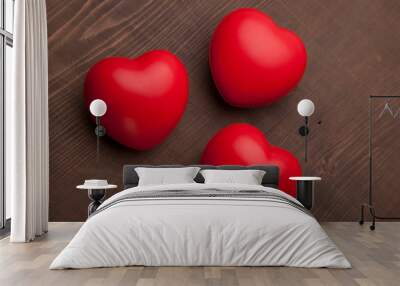 three red hearts on wooden background Wall mural