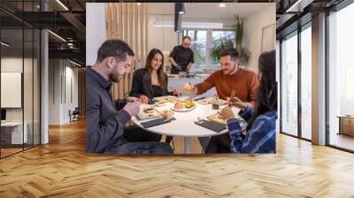 Group of people having dinner with private chef at home Wall mural