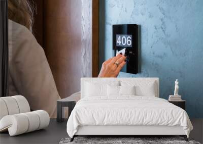 Hand on electronic hotel room access panel with room number Wall mural