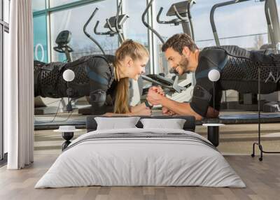 Man and woman doing electro muscular stimulation training in a modern gym Wall mural