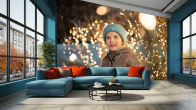 portrait of happy girl in winter evenings on background of Christmas lights Wall mural