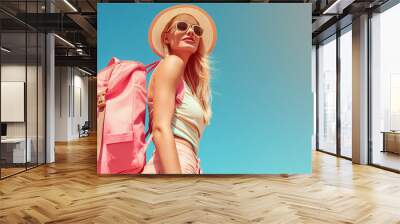 Trendy woman traveler with pink backpack and sunhat enjoying a bright sunny day Wall mural