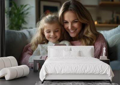 Happy mother and little daughter using smartphone sitting on sofa at home, scrolling social media, websurfing via phone gadget, Generative AI Wall mural