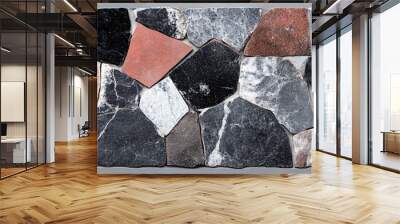 Colorful mosaic of irregular stone pieces creating a striking pattern. Wall mural