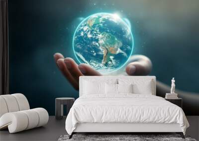 A hand is holding a globe Wall mural