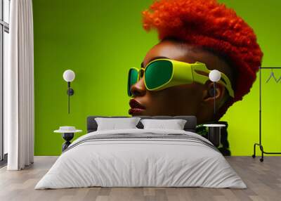 futuristic black punk woman with red hairstyle and sunglasses in front of a minimal green backdrop Wall mural