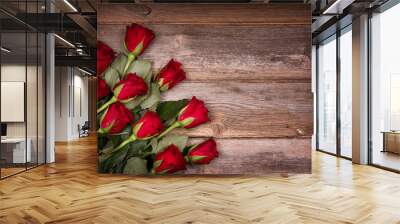 Red roses over old wood background with intentional vignette. Ideal image for Birthday, Valentine and celebration cards. Wall mural