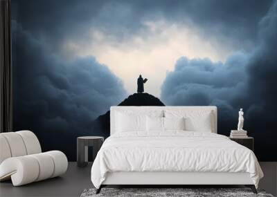 silhouette of person standing on mountain peak against cloudy sky Wall mural