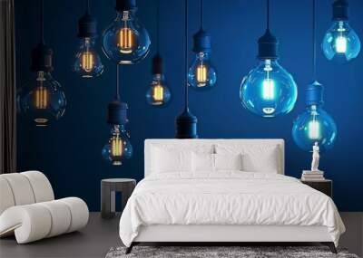 A creative display of hanging light bulbs with contrasting blue and orange filaments, symbolizing innovation and inspiration in a dark setting. Wall mural