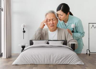 Elderly man having a headache, with a woman sitting beside him Wall mural