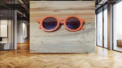 sunglasses on wooden table Wall mural