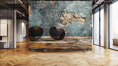 Men s sunglasses on wooden table against gray grunge wall Wall mural