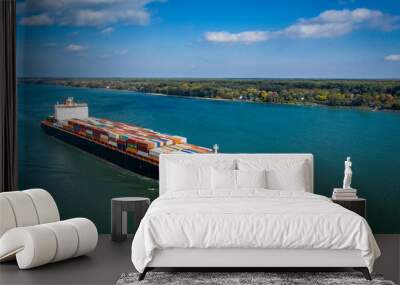 Aerial view of a container ship going upstream in the St. Lawrence River near the port of Montreal in Canada Wall mural