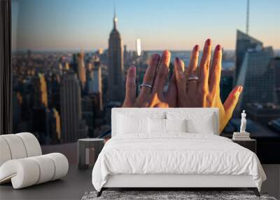 Hands with weeding rings with the Empire State in the background Wall mural