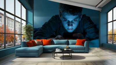 A child using smart phone lying in bed late at night, playing games. Children's screen addiction and parent control concept. Child's room at night. Sensitive content on screen Wall mural