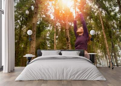 fit, sporty woman doing stretching exercises outside in the forest, outdoor fitness concept Wall mural