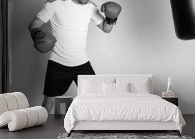 Athlete man training with boxing gloves on white background. Wall mural