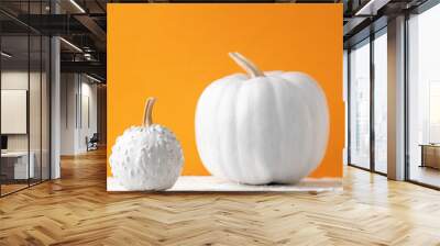 halloween background of pumpkin painted white in orange background Wall mural