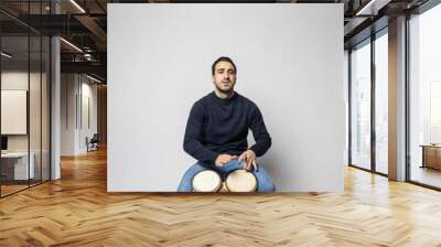 young man playing bongos on the white background Wall mural