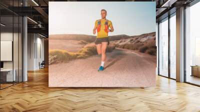 Young man running with greenish yellow shirt Wall mural