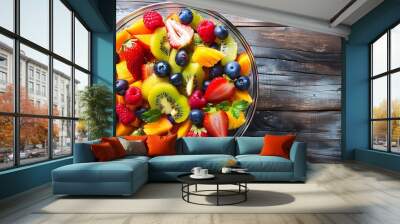 Bowl of healthy fresh fruit salad on wooden background Wall mural