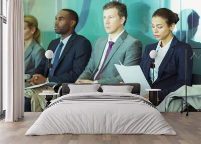 Business people sitting in waiting area Wall mural