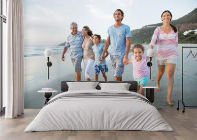 Family walking together on beach Wall mural