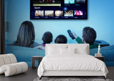 Family watching television in living room Wall mural