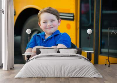 Happy young boy in front of school bus going back to school Wall mural