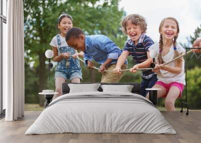 Children playing tug of war Wall mural