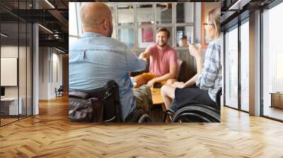 Friends sharing a moment at a cafe with person in a wheelchair demonstrating inclusion Wall mural