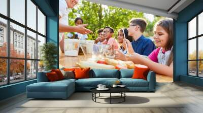 Group of kids has fun learning to cook Wall mural