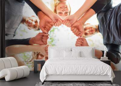 Group of teenagers in a circle with clenched fists Wall mural