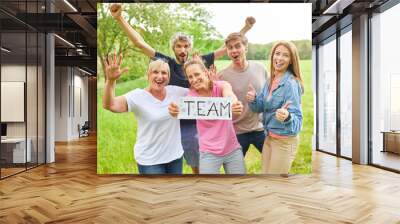 Group of young people celebrating success and holding a sign Wall mural