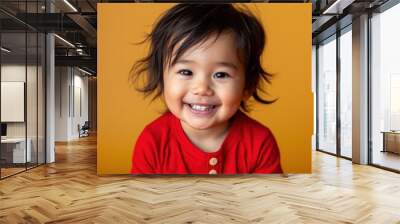 Happy Indigenous American toddler in bright red outfit against a yellow background Wall mural