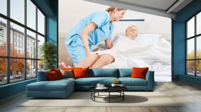 Nursing lady embeds senior patient Wall mural