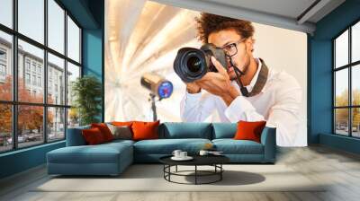 Photographer at the photo shoot with digital camera Wall mural