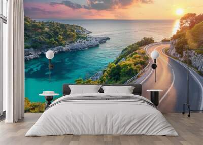 Scenic coastal road winding along turquoise water at sunset Wall mural