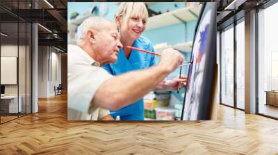 Senior man and therapist are painting together Wall mural