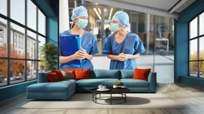 Two surgeons in blue surgical gown with surgical mask Wall mural