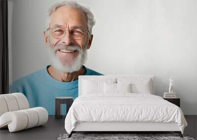 Mature, bearded man with a cheerful smile wearing a sweatshirt stands alone on a white background, looking at the camera mid-aged, gray-haired senior hipster Wall mural