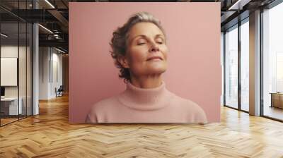 Medium shot portrait photography of a woman in her 50s practicing mindfulness, sophrology, relaxation & stress-reduction wearing a cozy sweater on pastel background. Generative AI Wall mural